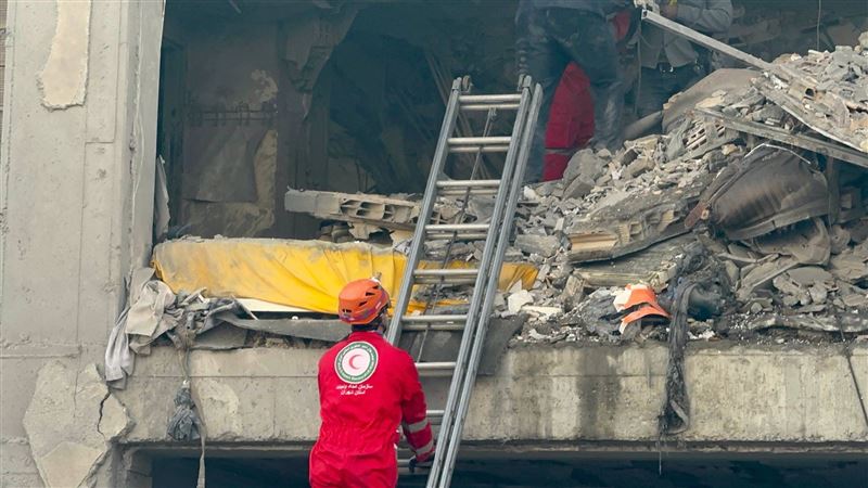 紅新月會人員爬上梯子到遇襲大樓二樓搜救。（圖／翻攝自X平台 @Iranian_RCS）