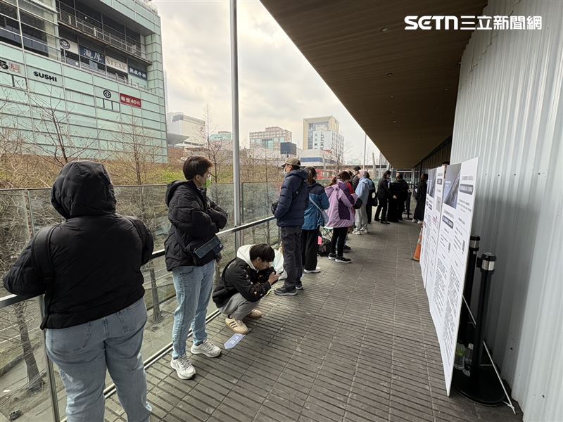 信義區「微風南山」今早8點50分現場人潮滿滿,有人自備椅子早早守候,有人邊站邊吃早餐等待,也有人坐在椅子上等到睡著;甚至有星粉坐在露營椅上,一邊使用筆電工作,一邊耐心排隊,顯示即便面對漲價壓力,粉絲對三星的支持與喜愛依然不減。(圖/記者王文承攝影)