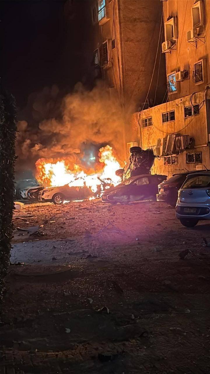 以色列中部大城特拉維夫15日凌晨再遭伊朗空襲。照片可見一輛汽車受波及後起火燃燒。（圖／翻攝自X平台 @BPINewsOrg）