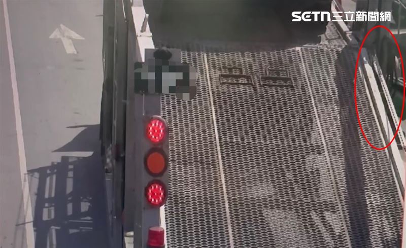 聯結車停等紅燈時，右側一台機車後座載著綠色保溫箱鑽過縫隙、緊貼聯結車身。（圖／翻攝畫面）