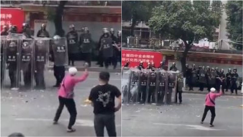 一位滿頭白髮的女村民拿起雞蛋投向警方，這一幕隨即在網路瘋傳，被網友譽為「抗爭典範」。（圖／翻攝自微博）