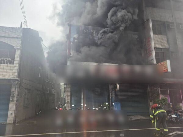 某機車行竄出火煙。（圖／翻攝畫面）