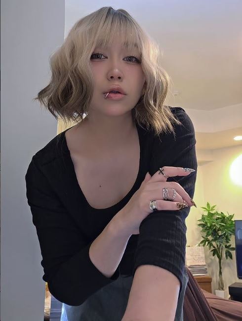 Ringo醬戴著波浪捲金髮短鮑伯假髮的自拍照，唇部搭配了唇環風格的飾品，加上比平時更具成熟韻味的妝容。（圖／翻攝自Ringo醬 IG）