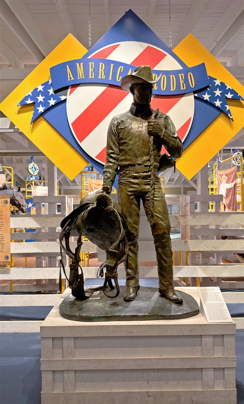 「AMERICAN RODEO」主題展區豎立牛仔雕像，手持套索與馬鞍搭配美國國旗意象，象徵美式牛仔競技與西部精神文化傳承。（圖／記者蕭翰弦攝影）