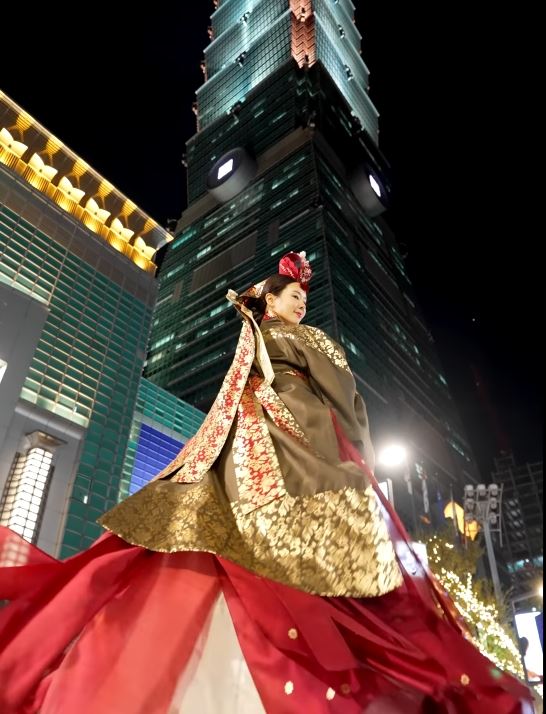 狐狸熊穿著韓國傳統服飾到台北101拍照,吸引不少民眾圍觀。(圖/翻攝韓國YouTuber「여우곰채널」頻道)