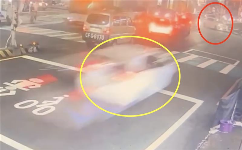 張男（黃圈）衝過路口時，一輛要迴轉的轎車（紅圈）機警的倒退。（圖／翻攝畫面）