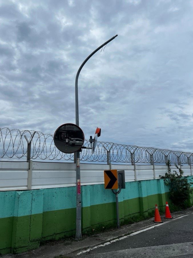 機場圍牆外的路燈疑遭戰機起落架撞壞。（圖／翻攝畫面）
