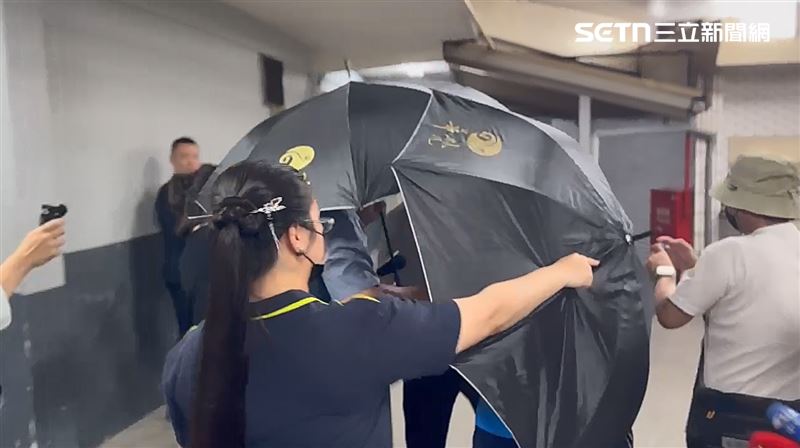台中和平區蝴蝶谷步道發生落石意外，造成4人死亡，死者家屬南下認屍，全程撐黑傘、一語不發。（圖／翻攝畫面）
