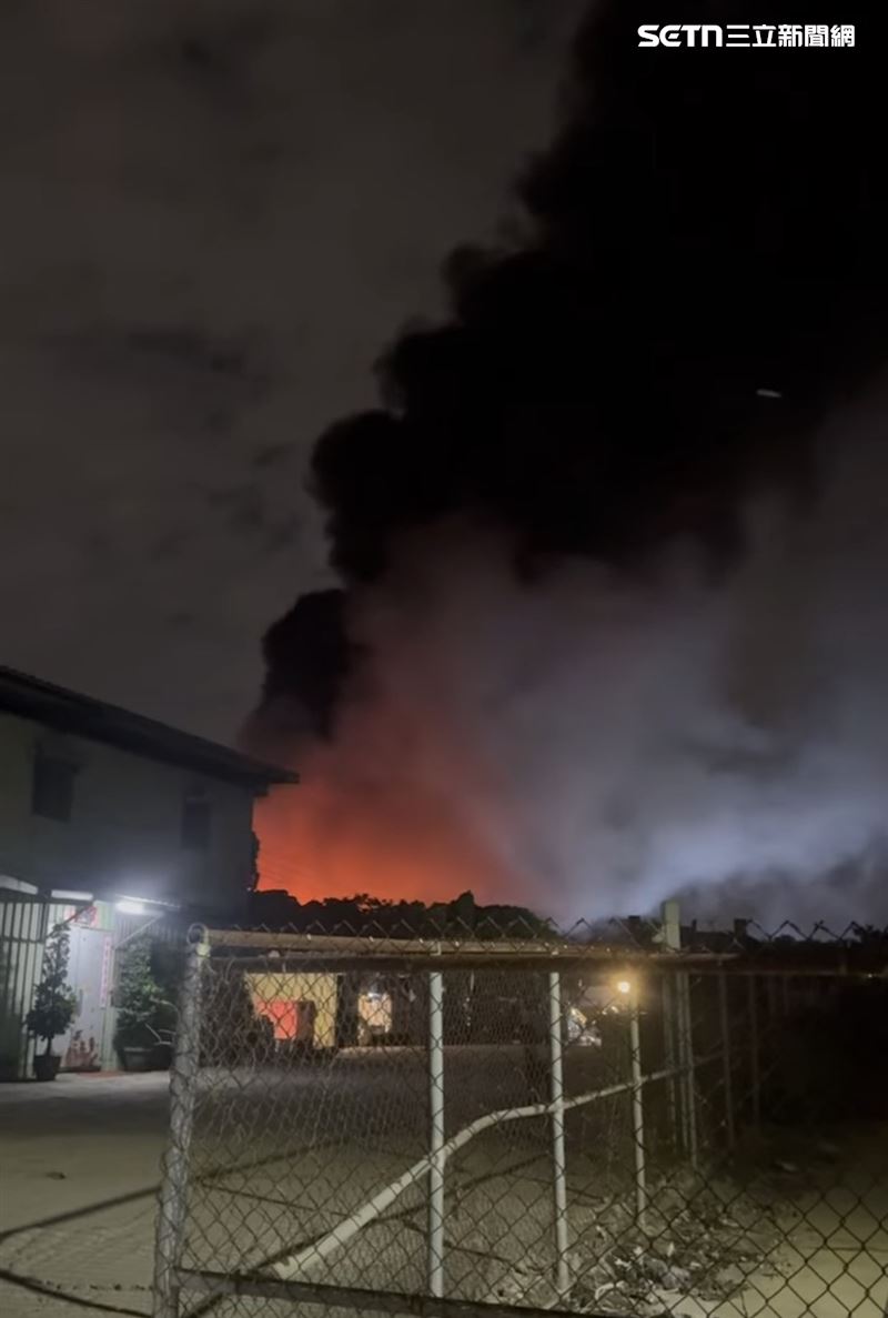 1 層樓高的鐵皮建築物早已被凶猛的火舌完全吞噬,高溫導致鐵皮屋頂與牆垮嚴重受熱變形,黑煙如巨龍般直衝天際,場面相當驚人。(圖/翻攝畫面)