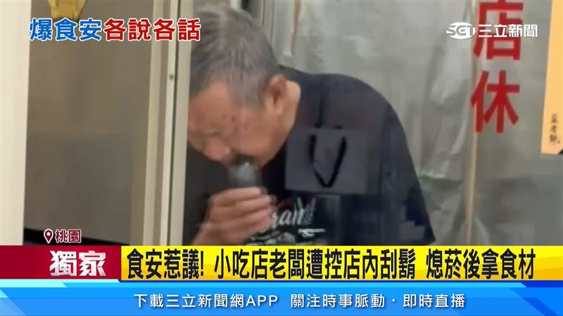 小吃店老闆拿著電動刮鬍刀在刮鬍子