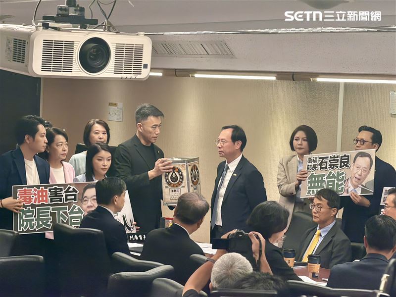 國民黨一行立委今日於立法院高舉標語、高喊院長下台,國民黨立法院黨團書記長林沛祥還拿著象徵毒油道具送給石崇良。(圖/記者蔣季容攝影)