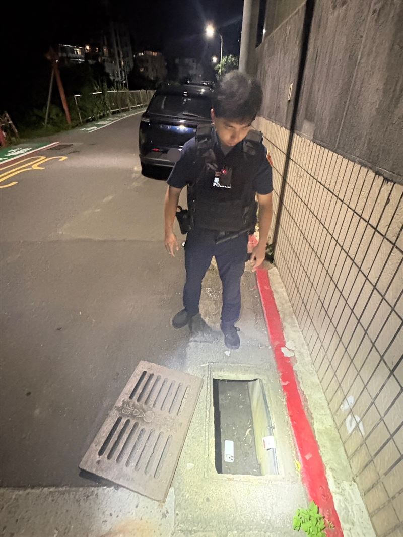 路過騎士表示曾聽到水溝內傳來鈴聲，警方一看果真在水溝蓋下發現手機。（圖／翻攝畫面）