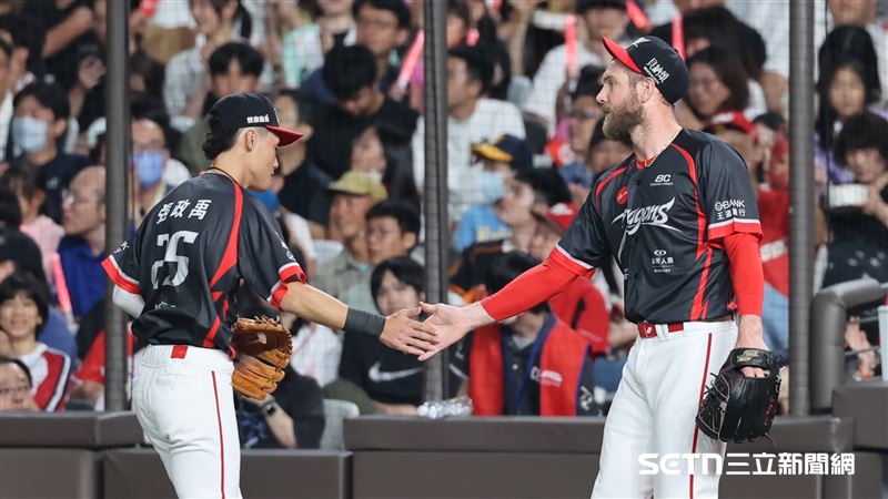 味全龍先發投手鋼龍和游擊手張政禹擊掌。(圖/記者劉彥池攝影)