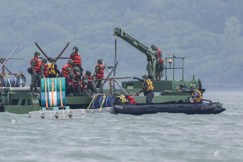 漢光42號實兵演習7日進入第3天，上午陸軍53工兵群在新北淡水執行「淡水河道阻絕設置」科目，工兵搭乘M3浮橋車與突擊舟，在河道放置鋼刺蝟阻絕設施。（圖／中央社）