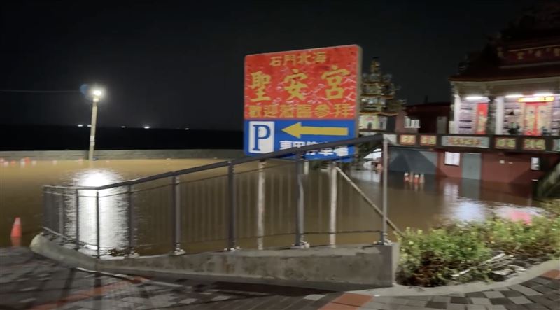 石門聖安宮停車場因排水不及嚴重淹水。(圖/翻攝畫面)