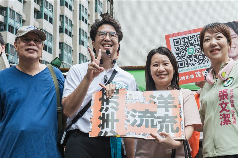 民進黨台北市長參選人沈伯洋今(30)日赴永春市場掃街拜票,一位民眾拿出復興國中畢業紀念冊要簽名,也意外曝光了沈伯洋國中的模樣。(圖/沈伯洋競辦提供)