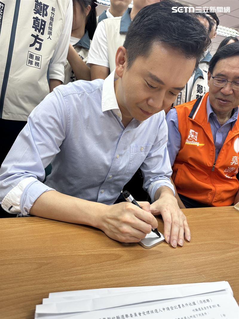 補件空檔不少支持者拿隨身物品給鄭朝方簽名。(圖/記者羅欣怡攝影)