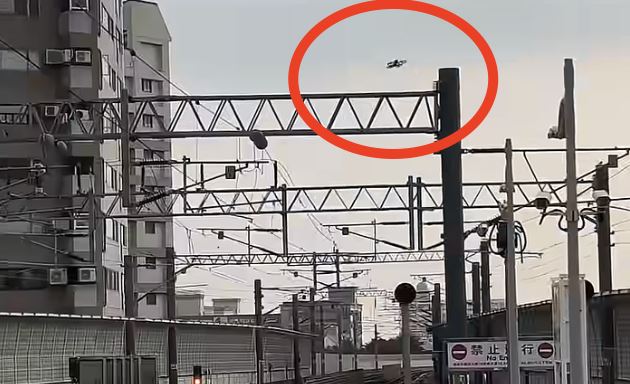 無人機不慎撞擊電桿掉落至鐵軌上。(圖/翻攝自YouTube Pohan的鐵路頻道)