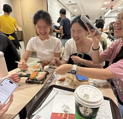香港一名網友近日分享用餐經歷,原本一個人坐4人桌,沒想到4名年輕女子「問都沒問」突然靠過來,幾乎沒先徵求同意就直接坐下,還拿出自備的壽司、月餅開吃,讓他當場傻眼。(圖/翻攝自Threads)