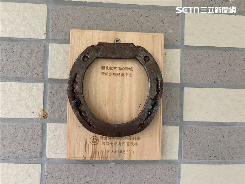 畜牧場牆上掛著象徵幸運的馬蹄鐵,盼馬場順遂平安。(圖/記者簡浩正攝影)
