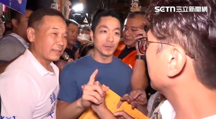蔣萬安、沈伯洋在萬華廣照宮,兩人短兵相接並握手。(圖/翻攝畫面)