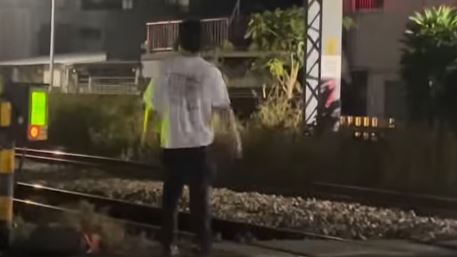男子跑到東區榮譽街平交道滯留,還拾取石塊丟擲,被PO網。(圖/翻攝自Threads @o.time777)