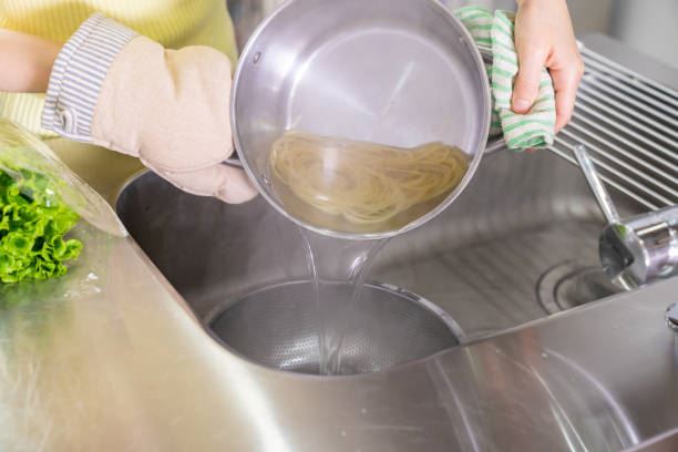 在家煮完水或烹調完料理後,許多人會順手把滾燙的熱水直接倒進廚房的水槽中。(示意圖/iStock)